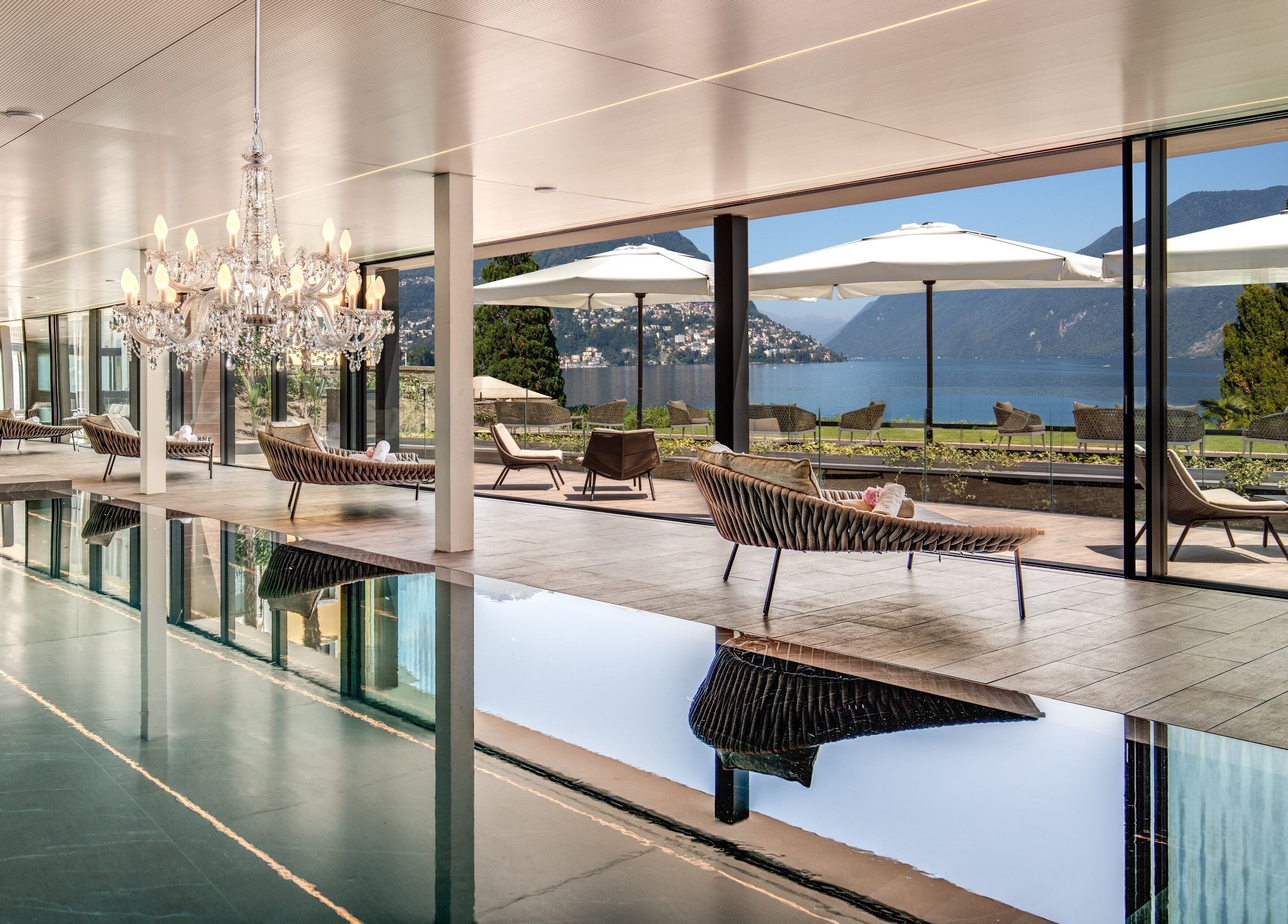 Luxurious pool area with chandeliers at Hotel Splendide Royal, Lugano, Ticino, CH offering lake views.