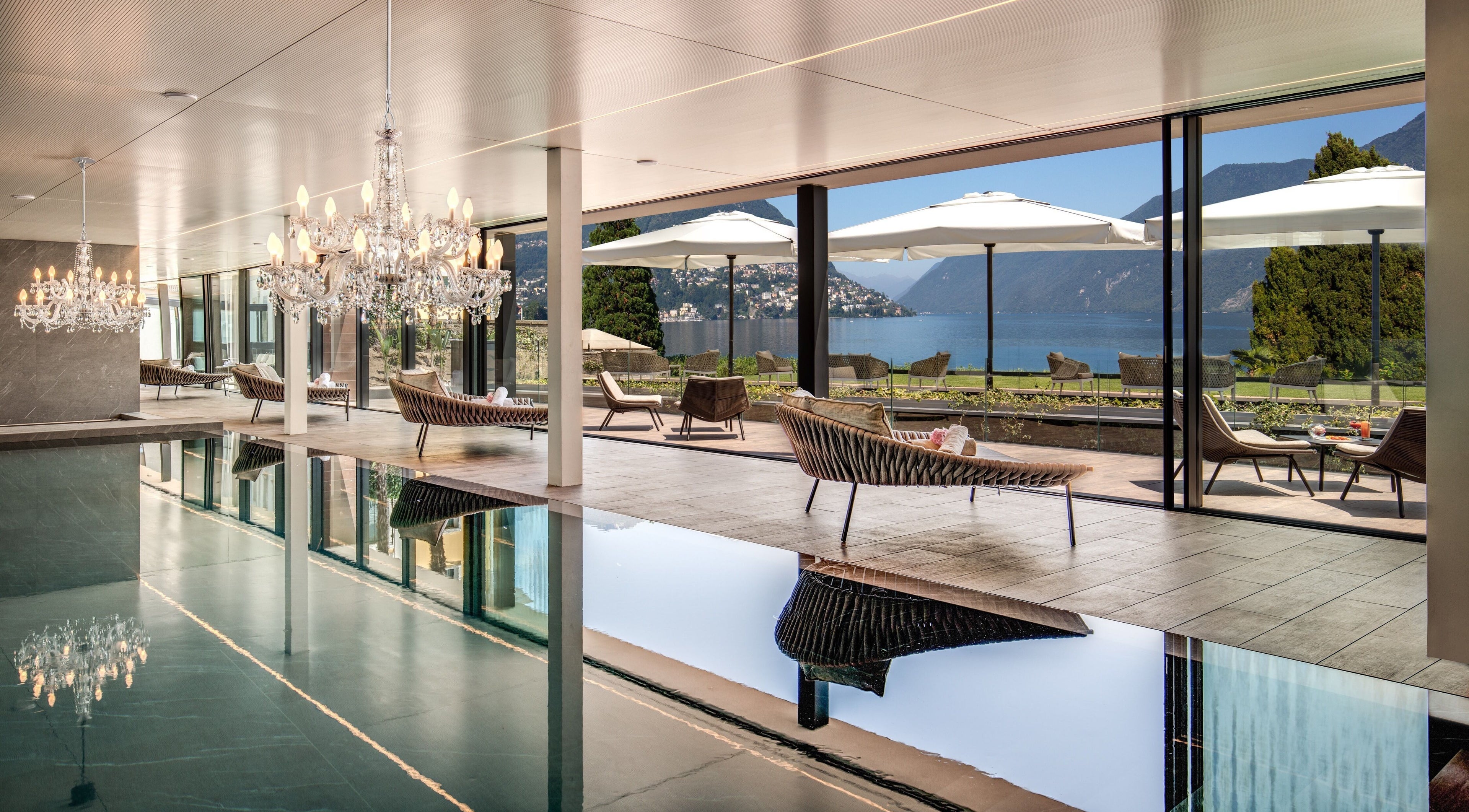 Luxurious pool area with chandeliers at Hotel Splendide Royal, Lugano, Ticino, CH offering lake views.