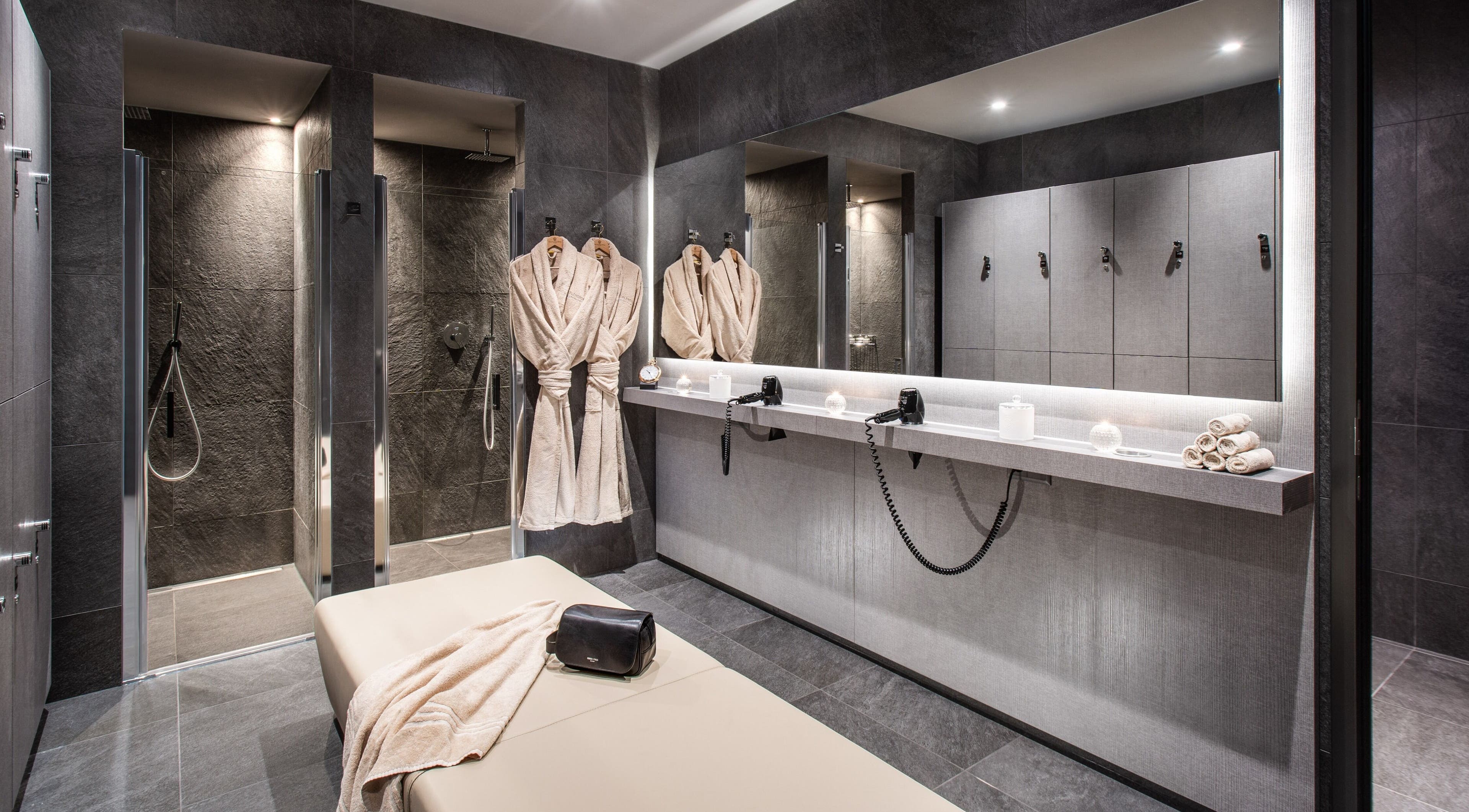 Luxurious spa facilities at Hotel Splendide Royal, Lugano, Ticino, CH with plush robes and modern showers.
