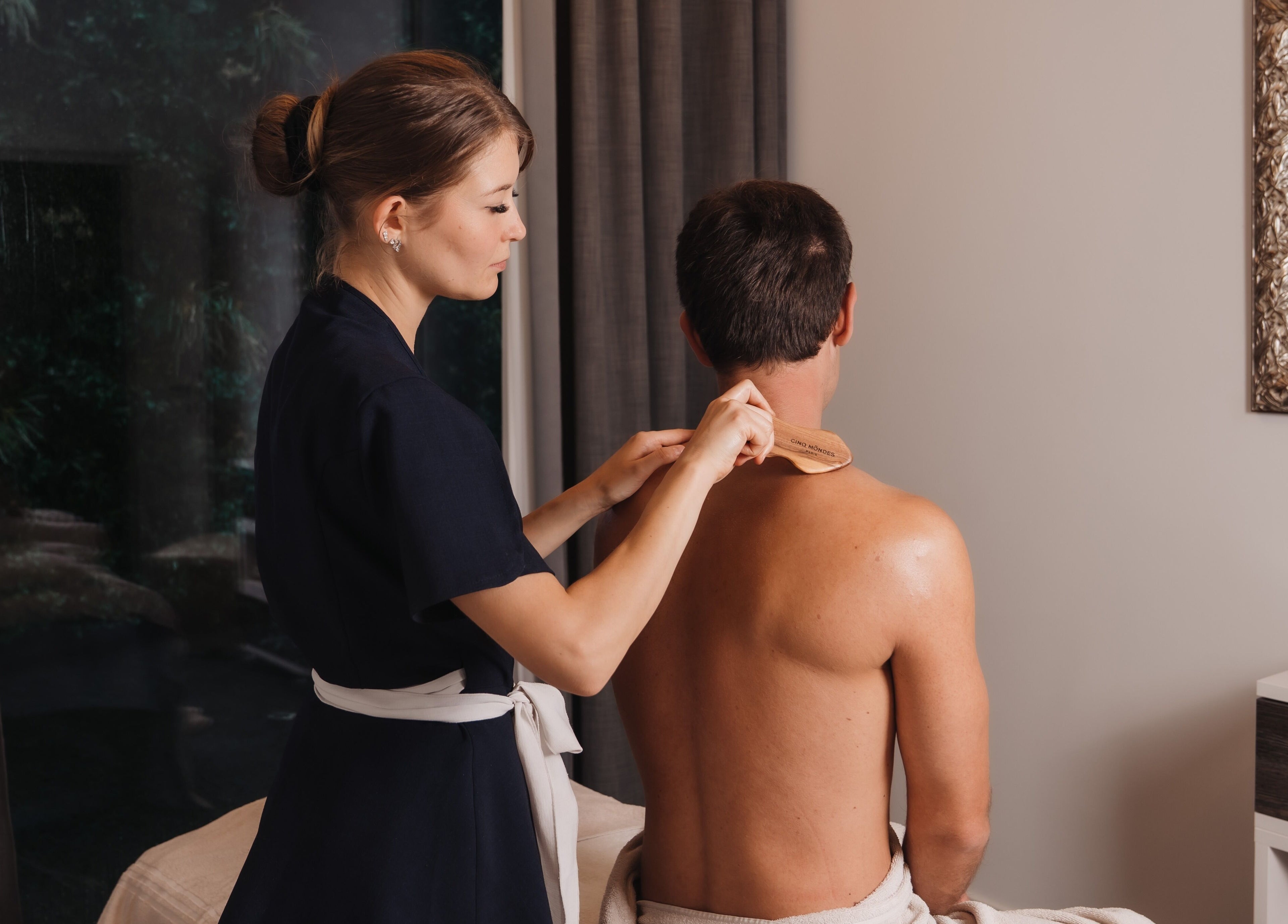 Therapist providing massage at Hotel Splendide Royal, Lugano, Ticino, CH. Elegant spa setting.