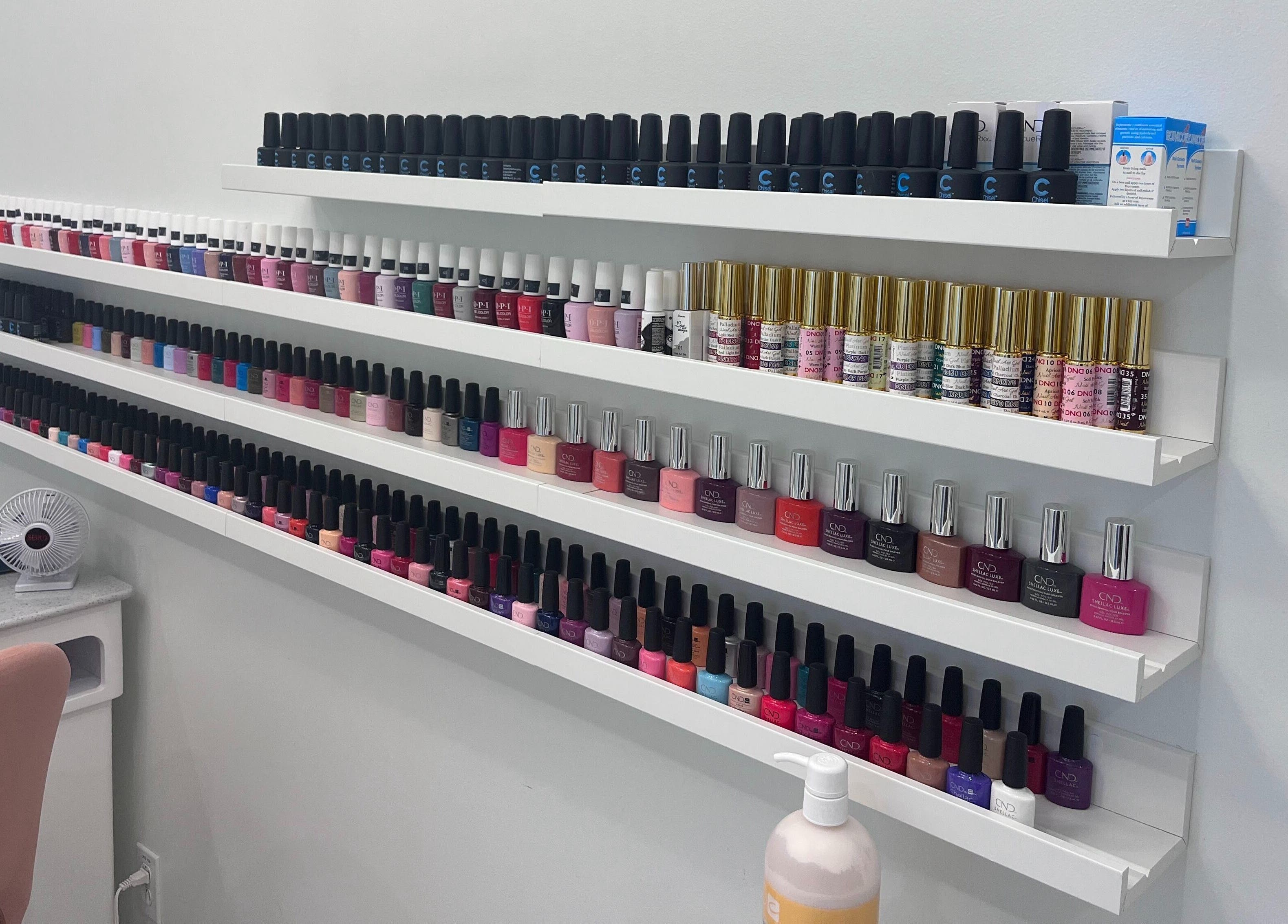 Vibrant nail polish collection at Dolly Lash Lounge in Pointe-Claire, Québec, CA, showcasing diverse colors.