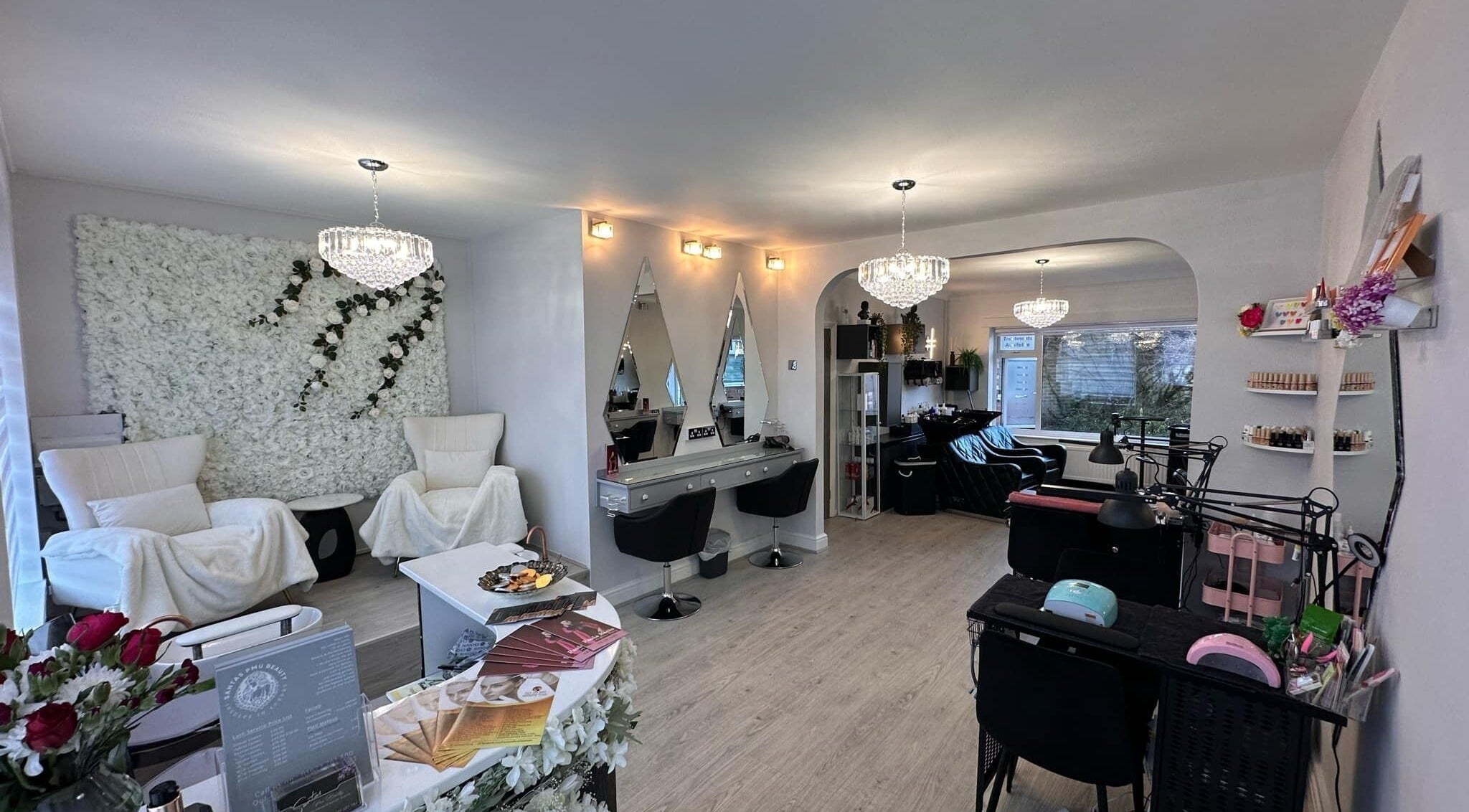 Elegant interior of Santa's PMU Beauty & Hair in Mansfield, England, GB with plush seating and chandeliers.