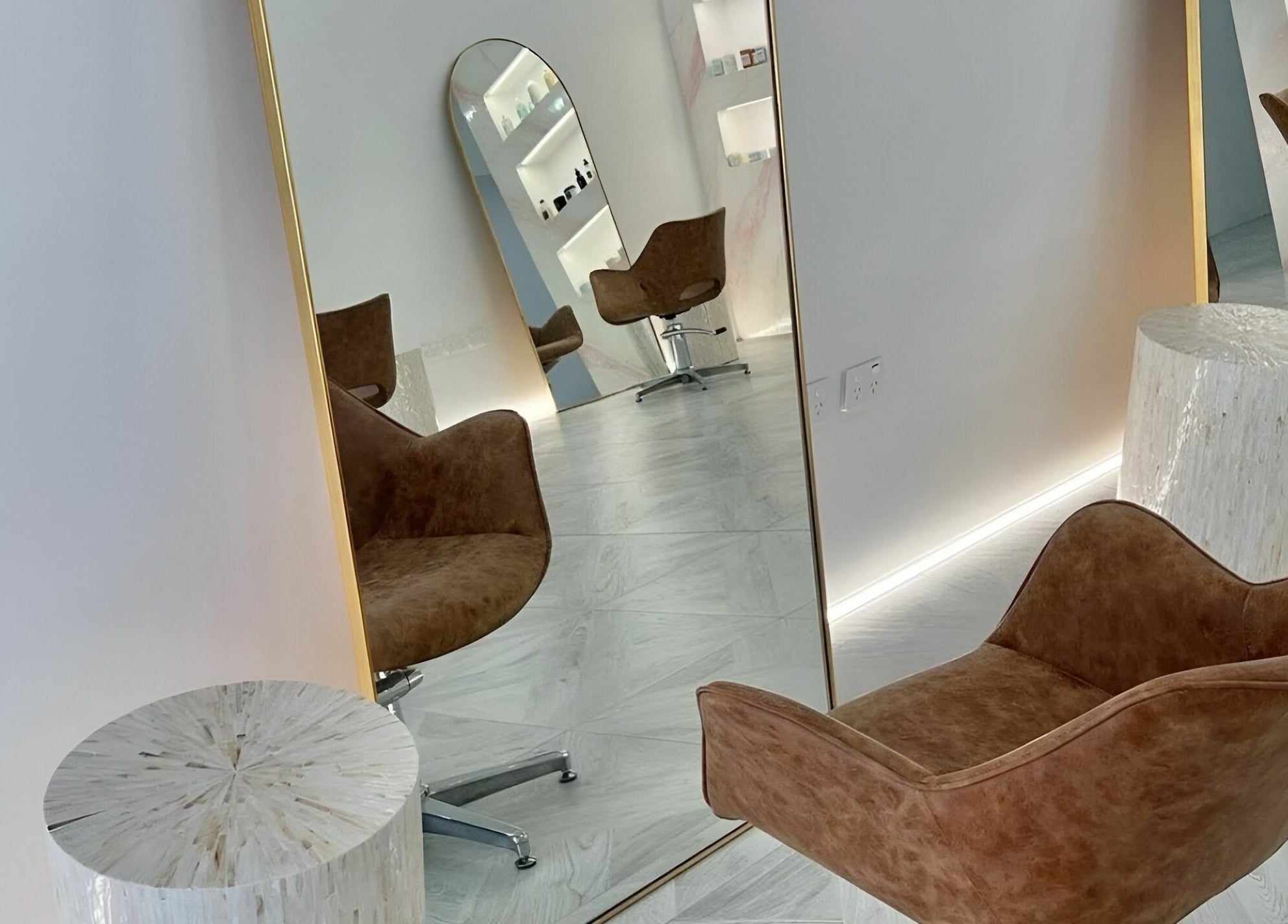 Stylish waiting area at Capelli and Co, The Entrance, New South Wales, AU featuring elegant mirrors and chairs.
