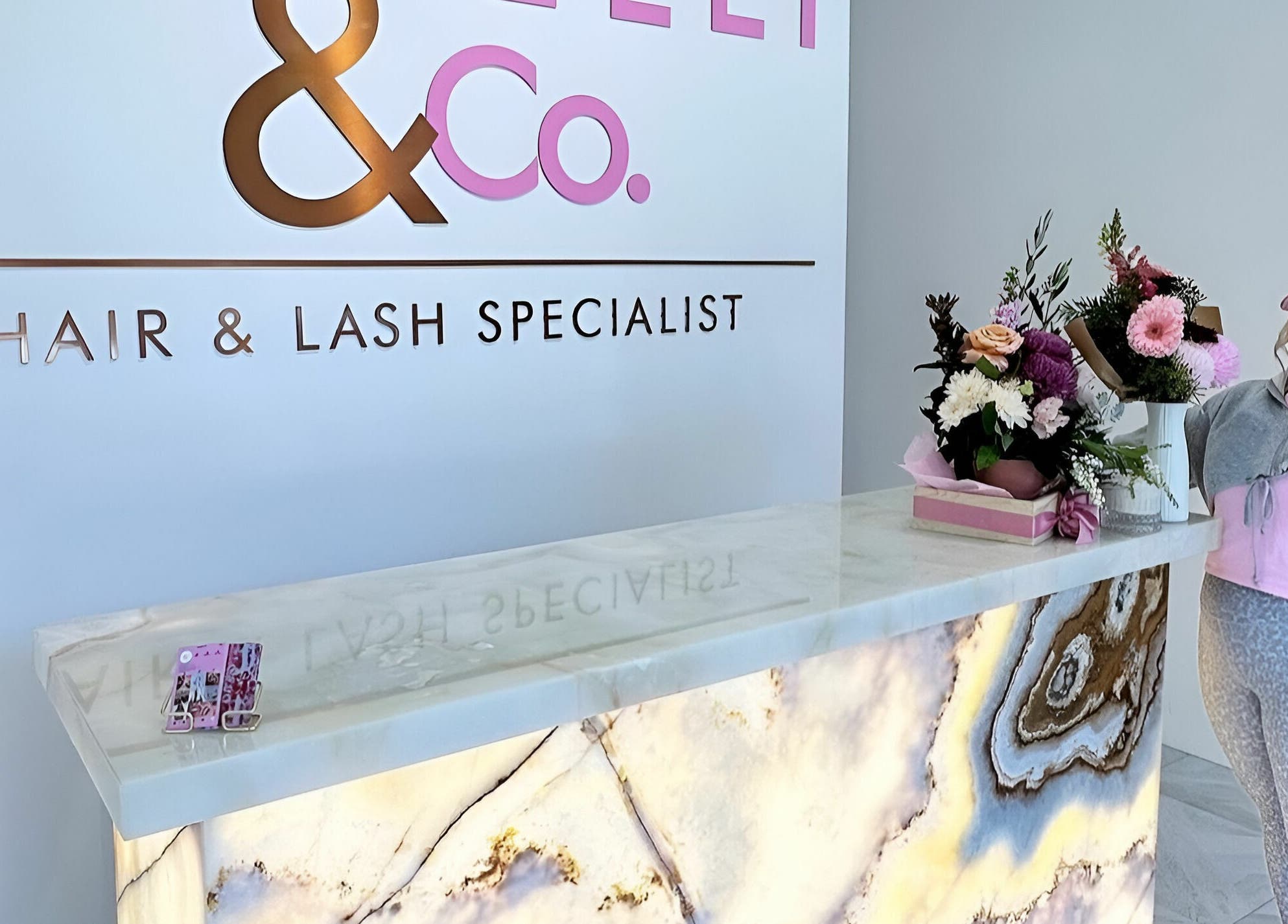 Elegant reception at Capelli and Co, The Entrance, New South Wales, AU with floral display and branding.