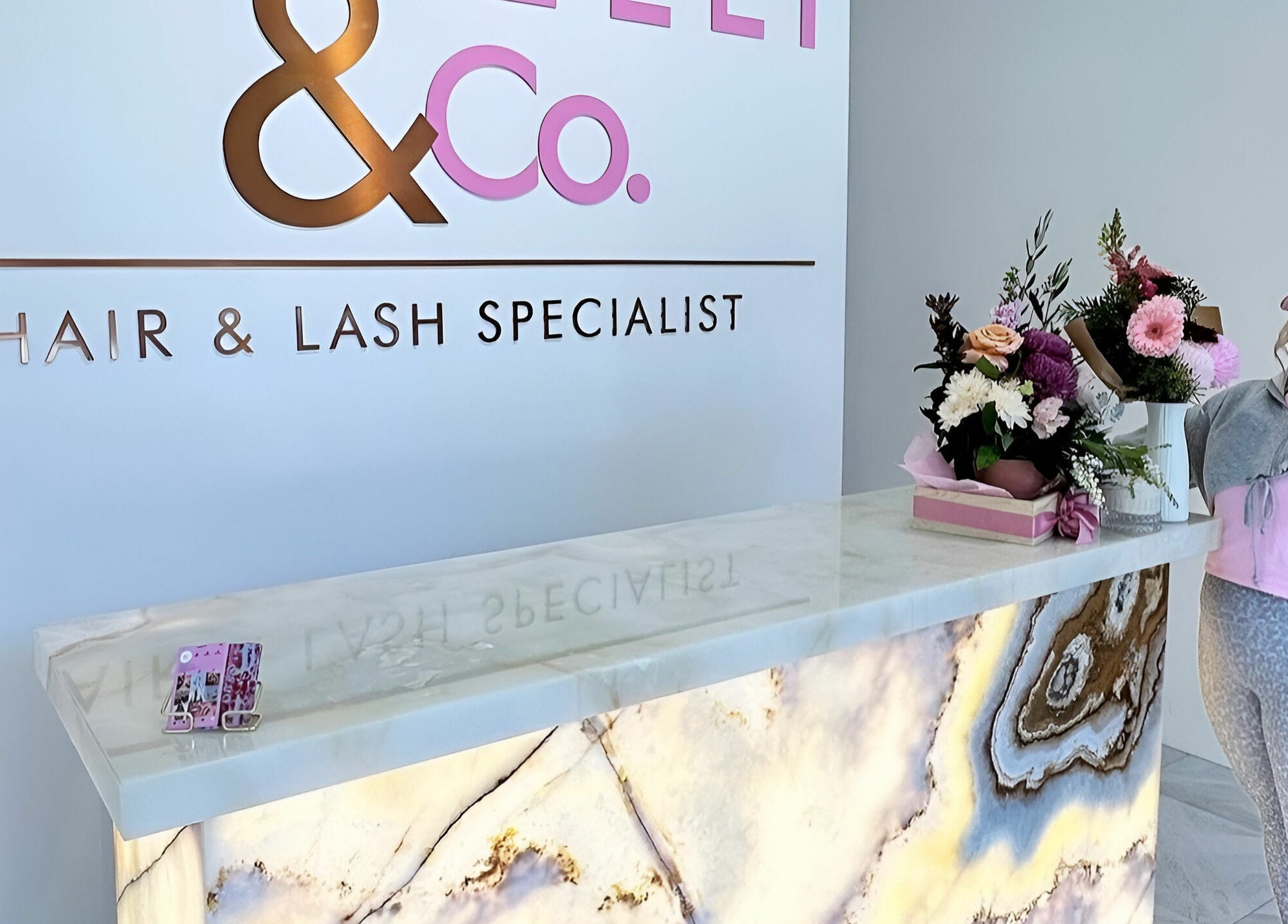Elegant reception at Capelli and Co, The Entrance, New South Wales, AU with floral display and branding.