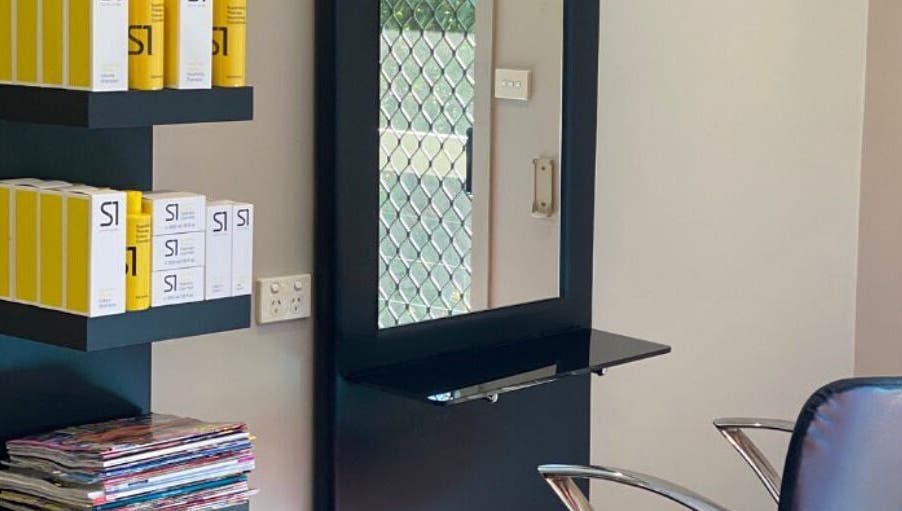 Interior view of Hair By Megan in Latham, AU featuring a stylish salon setup with shelves and products.