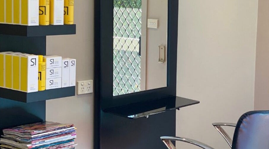 Interior view of Hair By Megan in Latham, AU featuring a stylish salon setup with shelves and products.