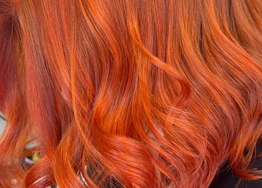 Vibrant red hair styled in waves at Hair By Megan, Latham, Australian Capital Territory, AU.