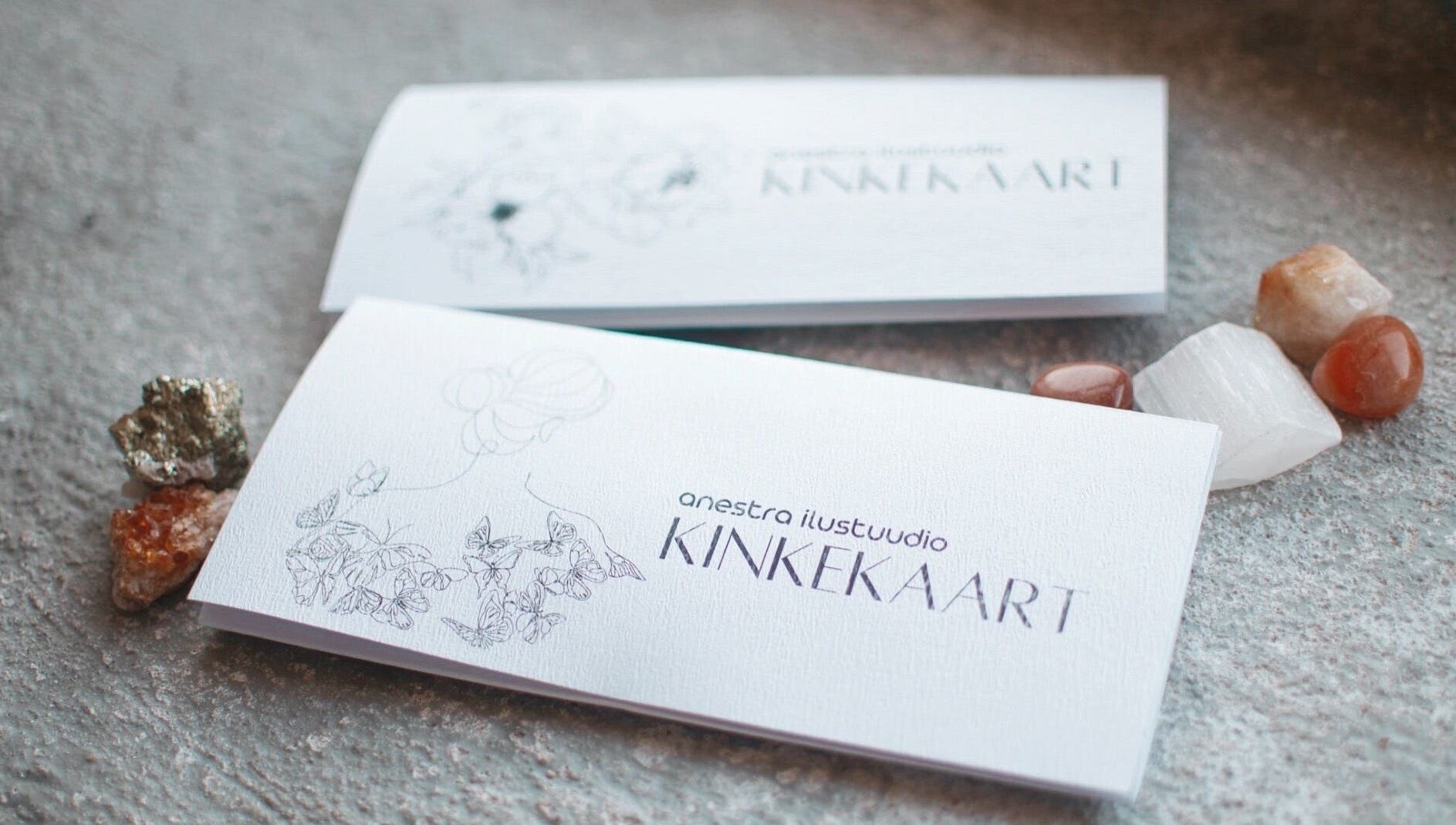 Elegant gift card for Anestra Ilustuudio, Tallinn, Harju maakond, EE, surrounded by decorative stones.