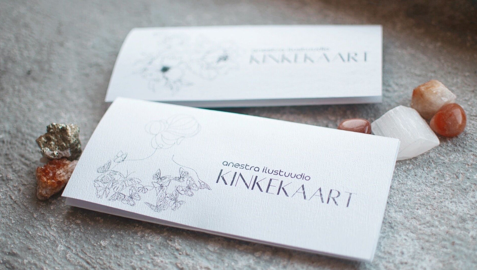 Elegant gift card for Anestra Ilustuudio, Tallinn, Harju maakond, EE, surrounded by decorative stones.