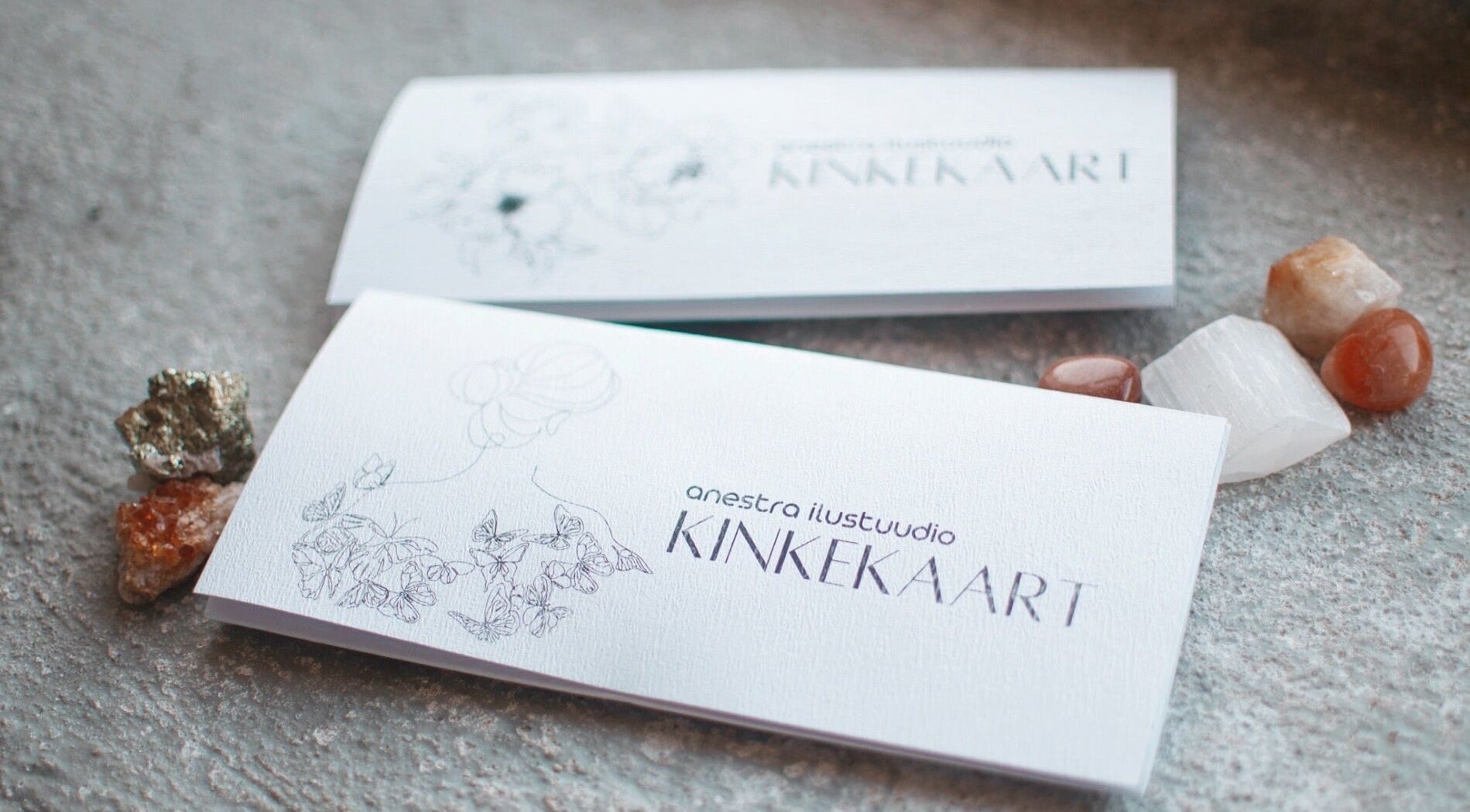 Elegant gift card for Anestra Ilustuudio, Tallinn, Harju maakond, EE, surrounded by decorative stones.