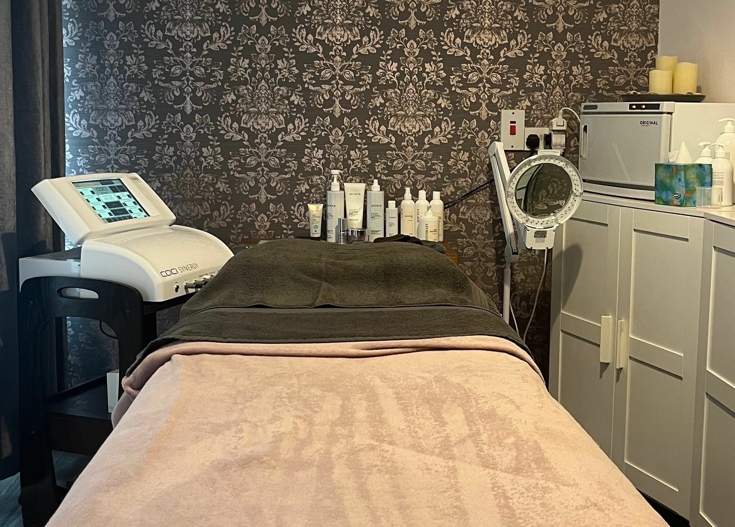 Treatment room at Still Beauty, Rathdowney, County Laois, IE with spa bed and skincare products.