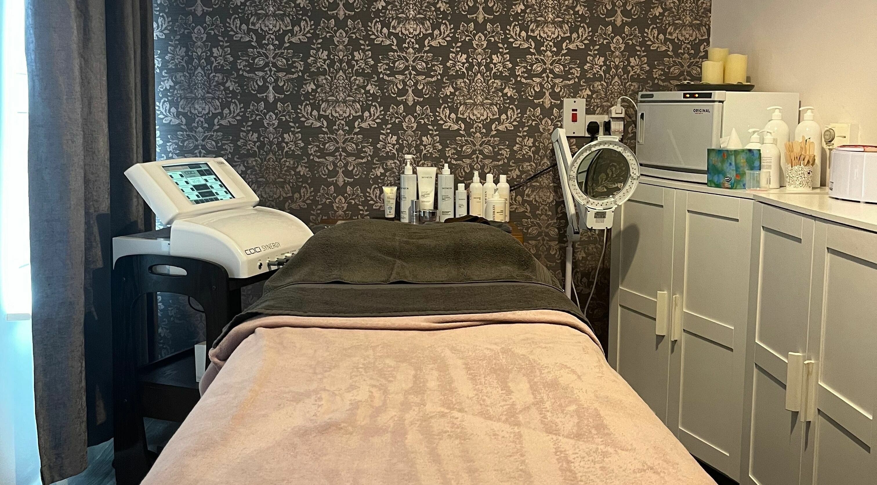 Treatment room at Still Beauty, Rathdowney, County Laois, IE with spa bed and skincare products.