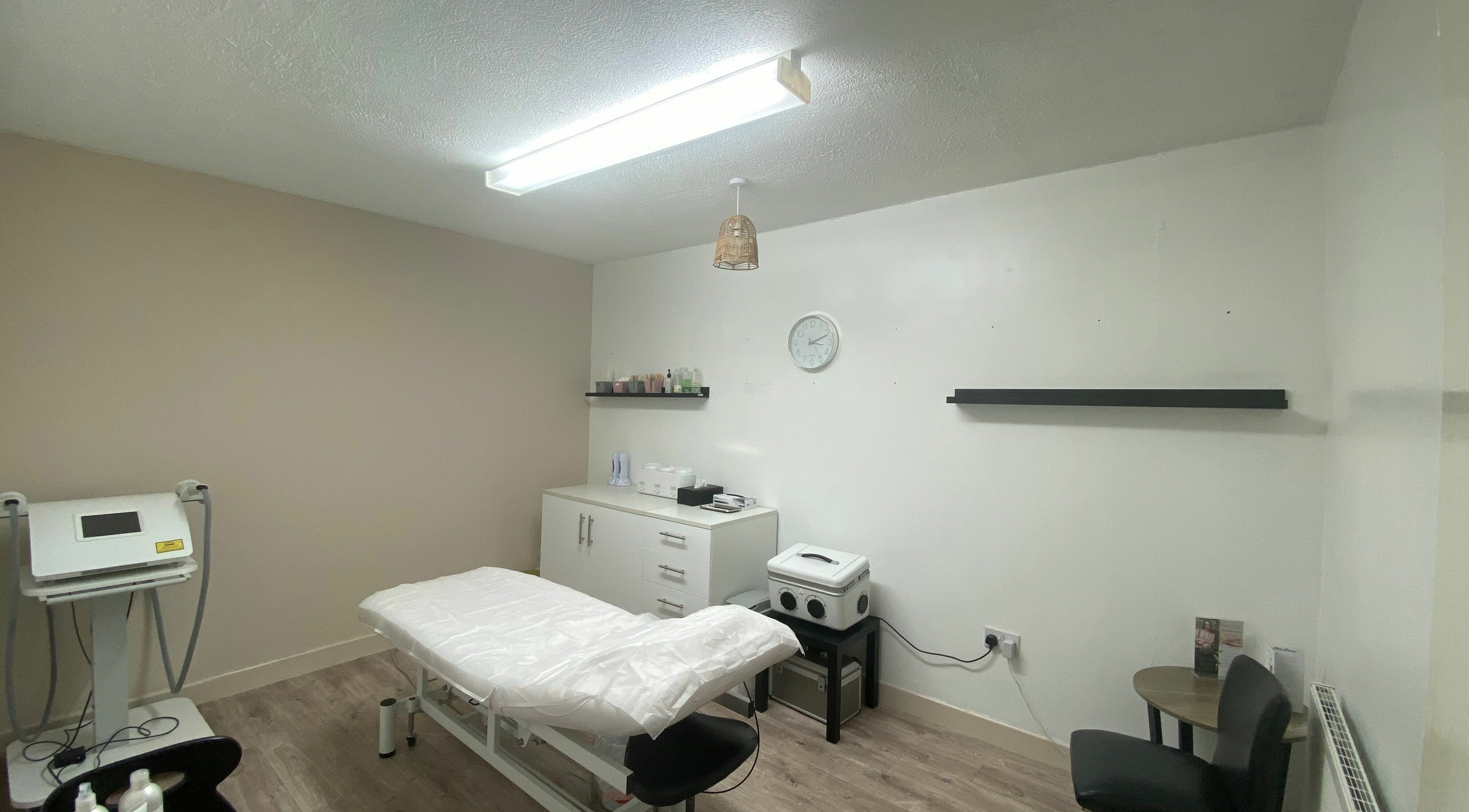A tranquil treatment room at Gaynor Louise Beauty & Aesthetics, Bury, England, GB featuring a massage table.