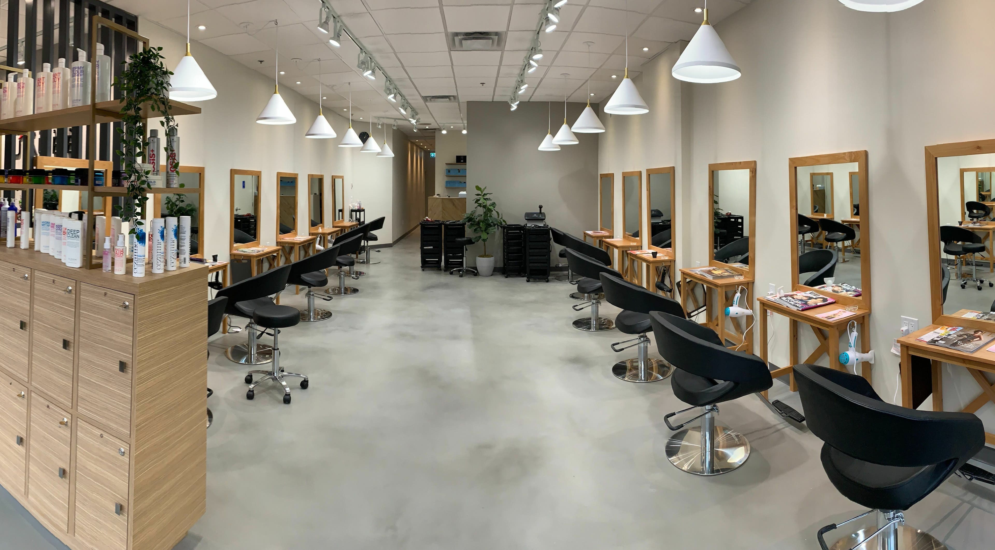 Chic interior of Aube Hair | Hornby in Vancouver, British Columbia, CA with stylish salon chairs and mirrors.
