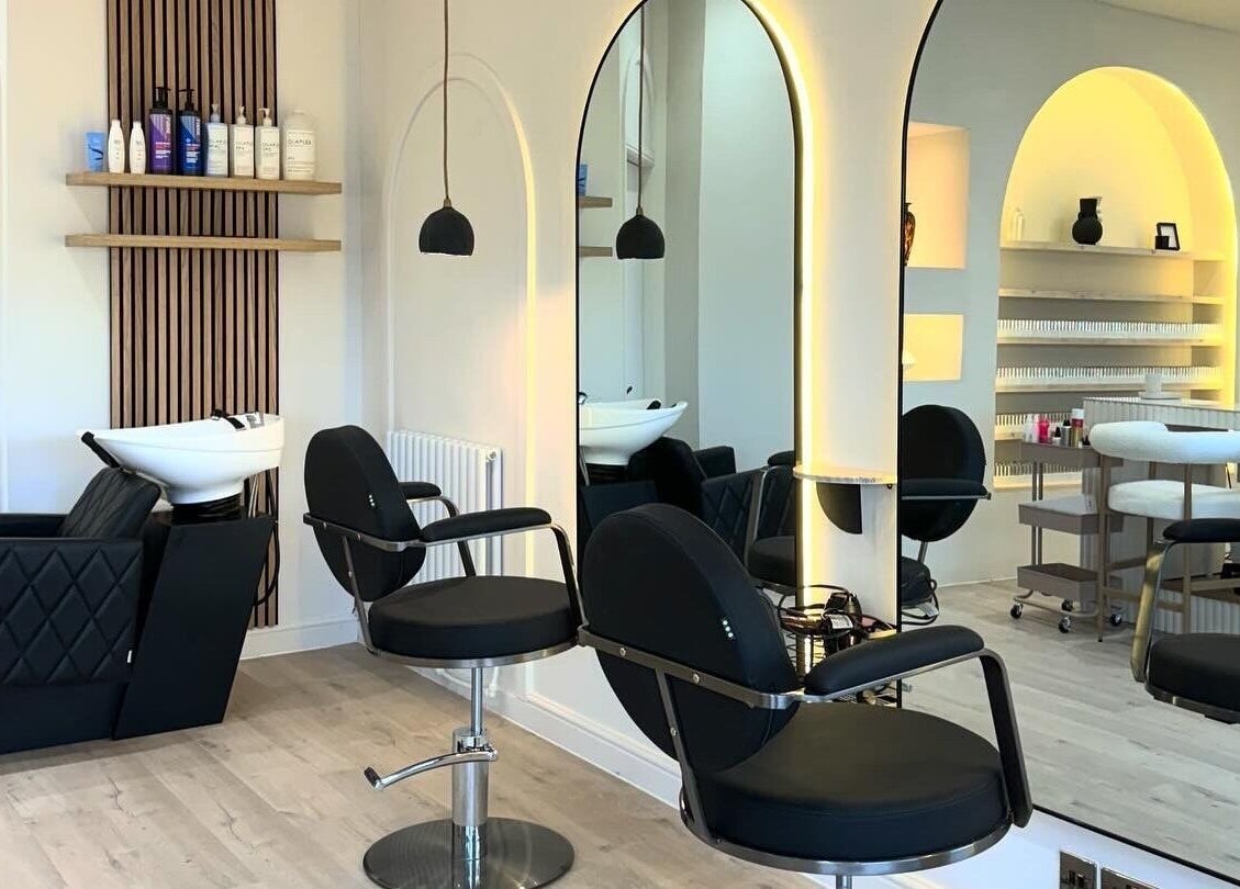 Sophisticated salon interior at House of Coco in Northwich, England, GB with modern black chairs and stylish mirrors.