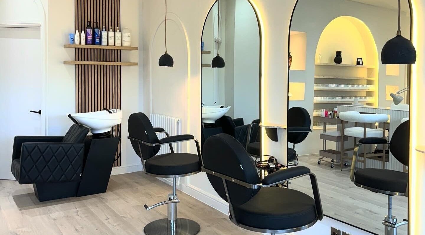 Sophisticated salon interior at House of Coco in Northwich, England, GB with modern black chairs and stylish mirrors.