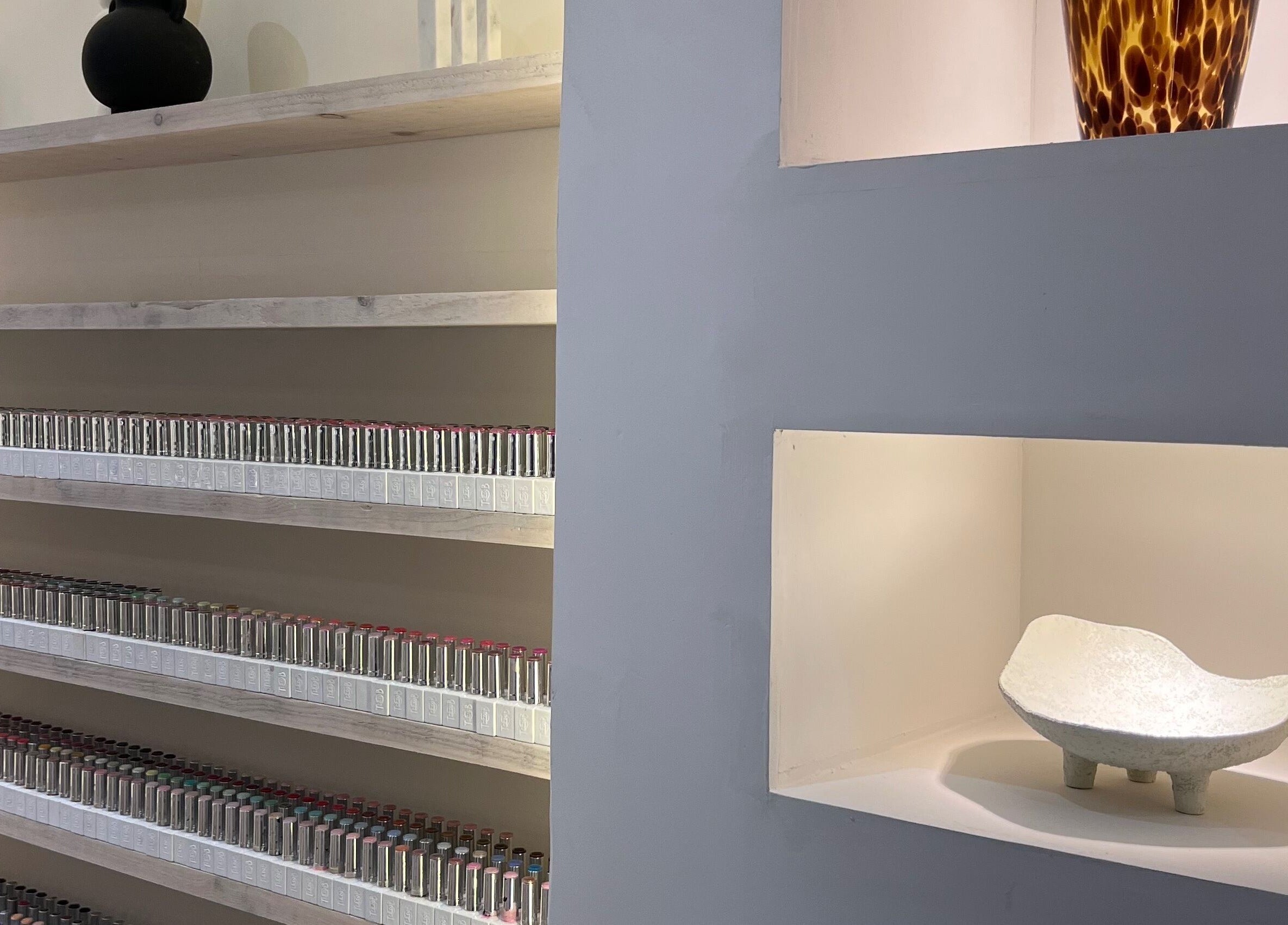 Stylish shelves with beauty products and decor at House of Coco, Northwich, England, GB.