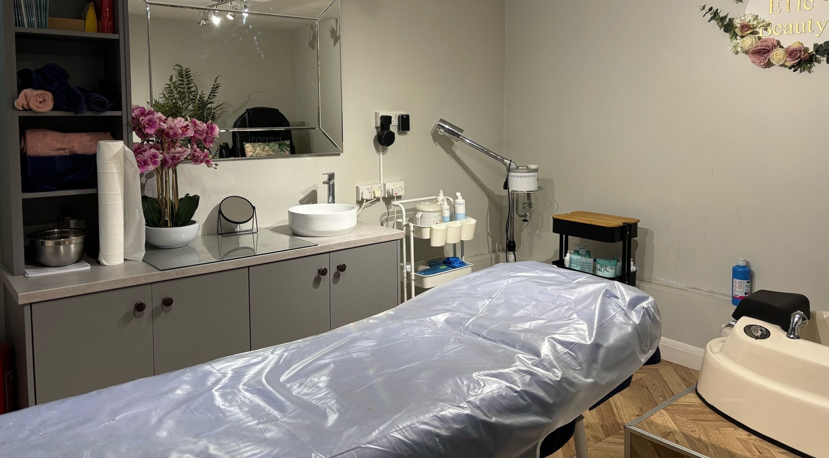 A relaxing treatment room at Elle Body and Beauty Randalstown, Northern Ireland, GB with tranquil decor.