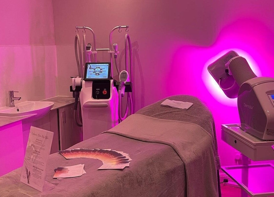 Bella Salon's serene treatment room with pink lighting in Nairn, Scotland, GB, featuring advanced beauty equipment.