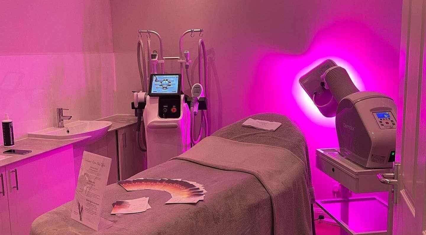 Bella Salon's serene treatment room with pink lighting in Nairn, Scotland, GB, featuring advanced beauty equipment.