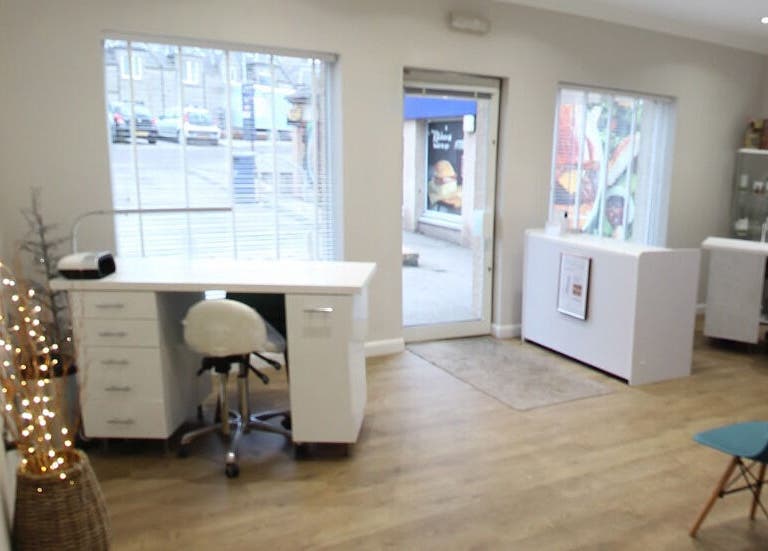 Inviting interior of Bella Salon in Nairn, Scotland, GB showcasing modern design with large windows and cozy seating.