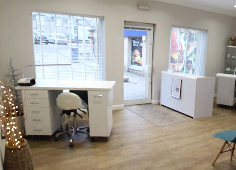 Inviting interior of Bella Salon in Nairn, Scotland, GB showcasing modern design with large windows and cozy seating.