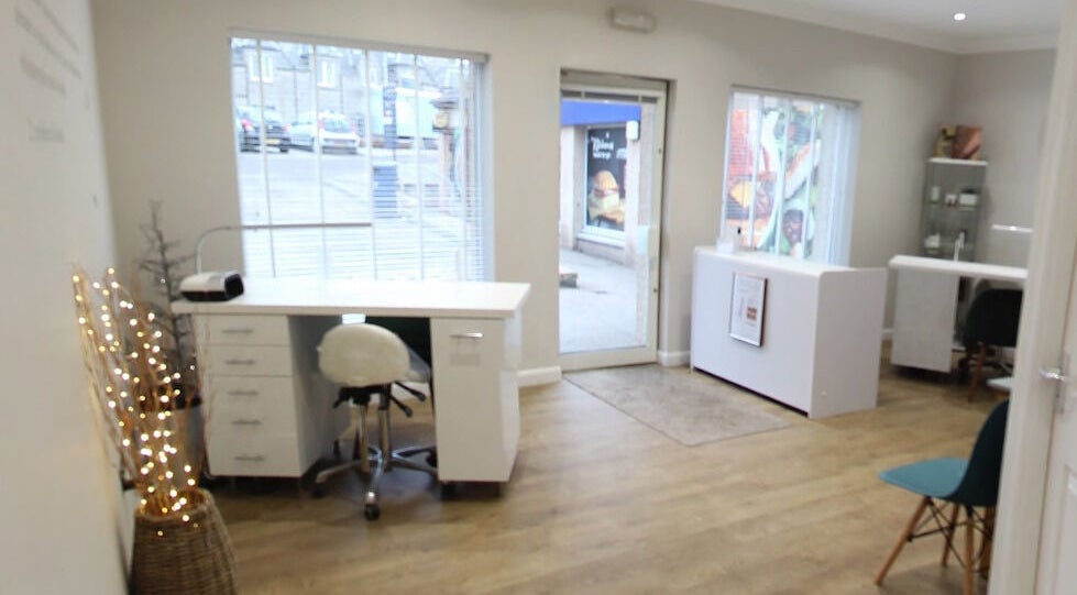 Inviting interior of Bella Salon in Nairn, Scotland, GB showcasing modern design with large windows and cozy seating.