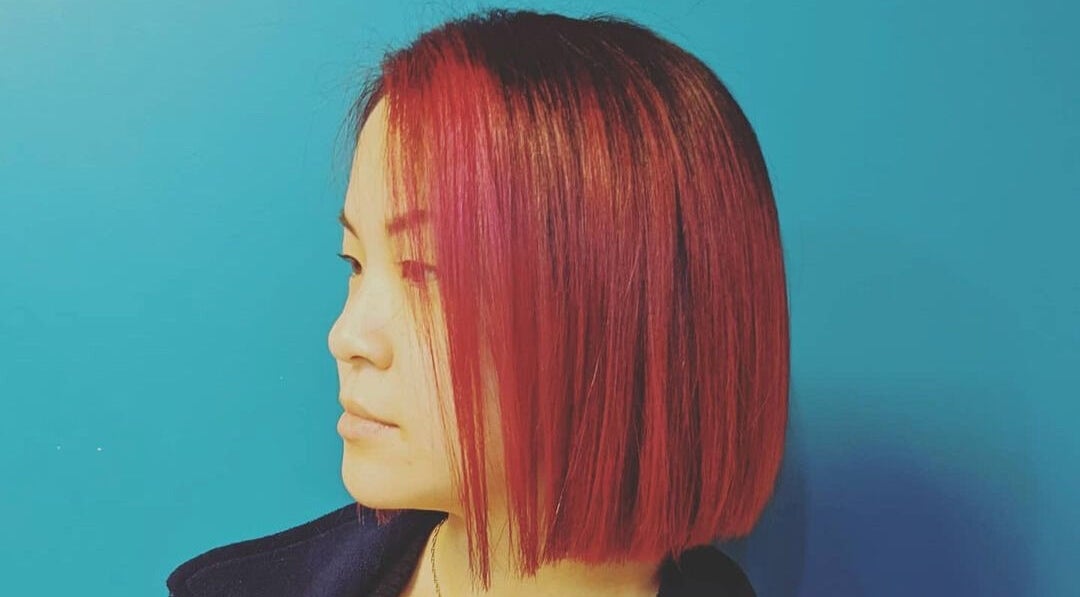 Side view of vibrant red bob hairstyle at Ritual Salon, Urbana, Illinois, US.