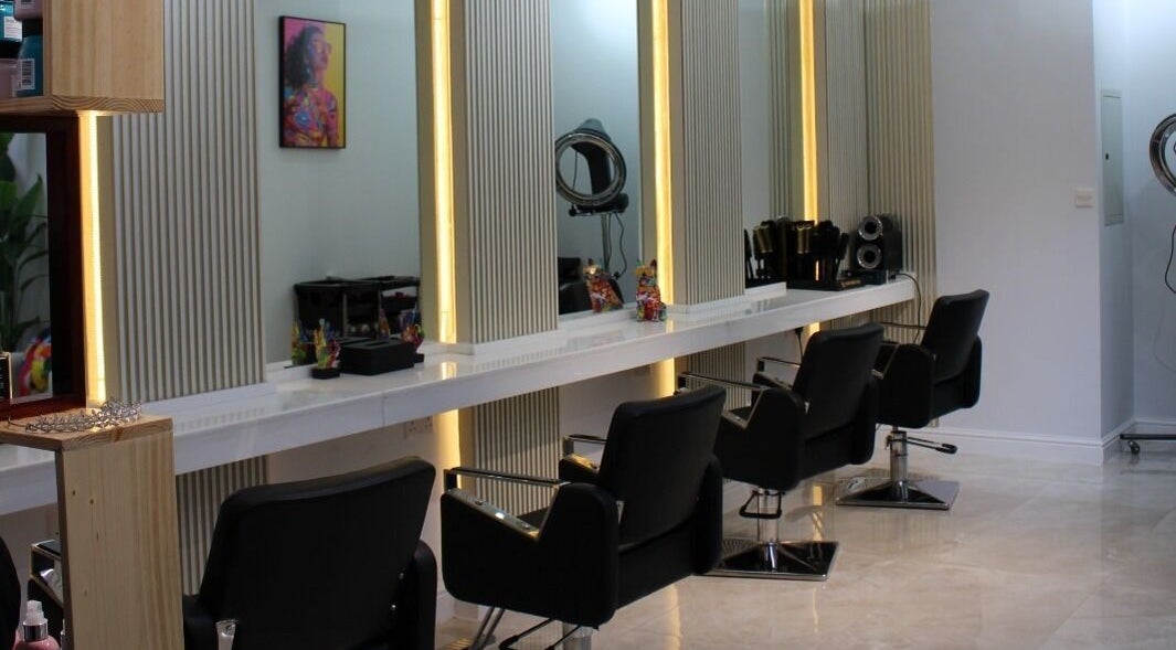 Chic styling area at Rana Balhas Beauty Center - Ayla Grand Hotel, Al Ain, Abu Dhabi, AE with sleek salon chairs.