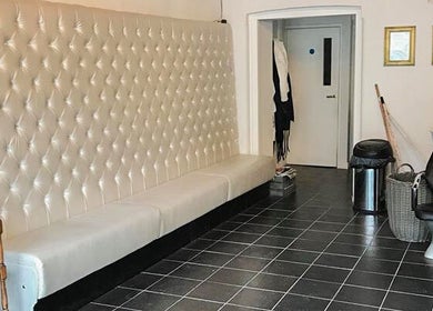 Elegant seating area at Charlotte's salon in Glossop, England, GB featuring plush decor.