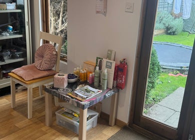 Cozy corner at Charlotte's, Glossop, England, GB with beauty products and a garden view.