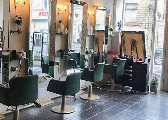 Chic salon interior with modern styling chairs at Charlotte's, Glossop, England, GB.