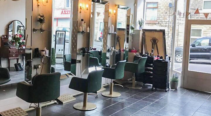 Chic salon interior with modern styling chairs at Charlotte's, Glossop, England, GB.