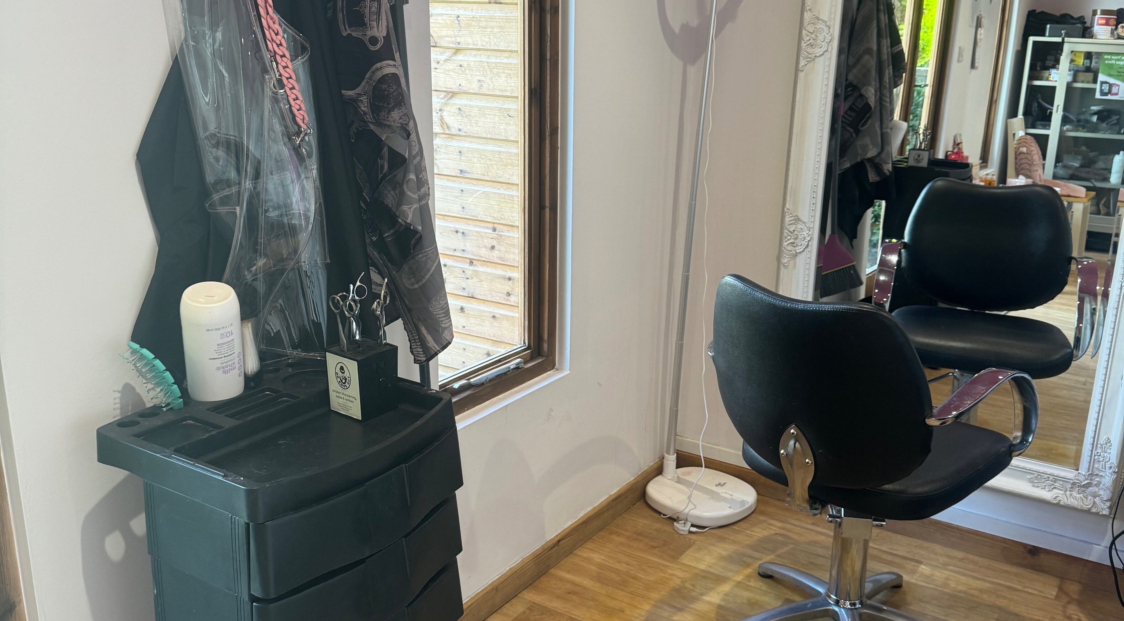 Cozy salon chair and equipment in Charlotte's, Glossop, England, GB, inviting for beauty services.