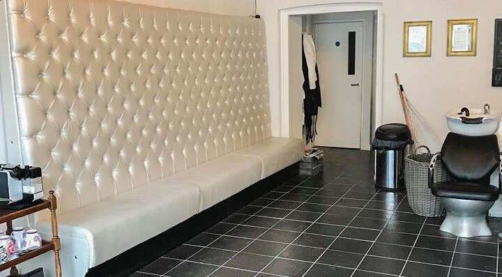 Luxurious seating and styling chair at Charlotte's, Glossop, England, GB. Modern salon interior.