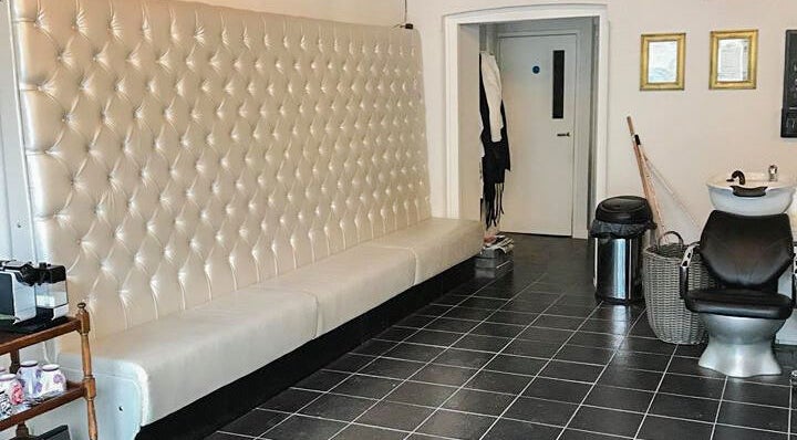 Luxurious seating and styling chair at Charlotte's, Glossop, England, GB. Modern salon interior.
