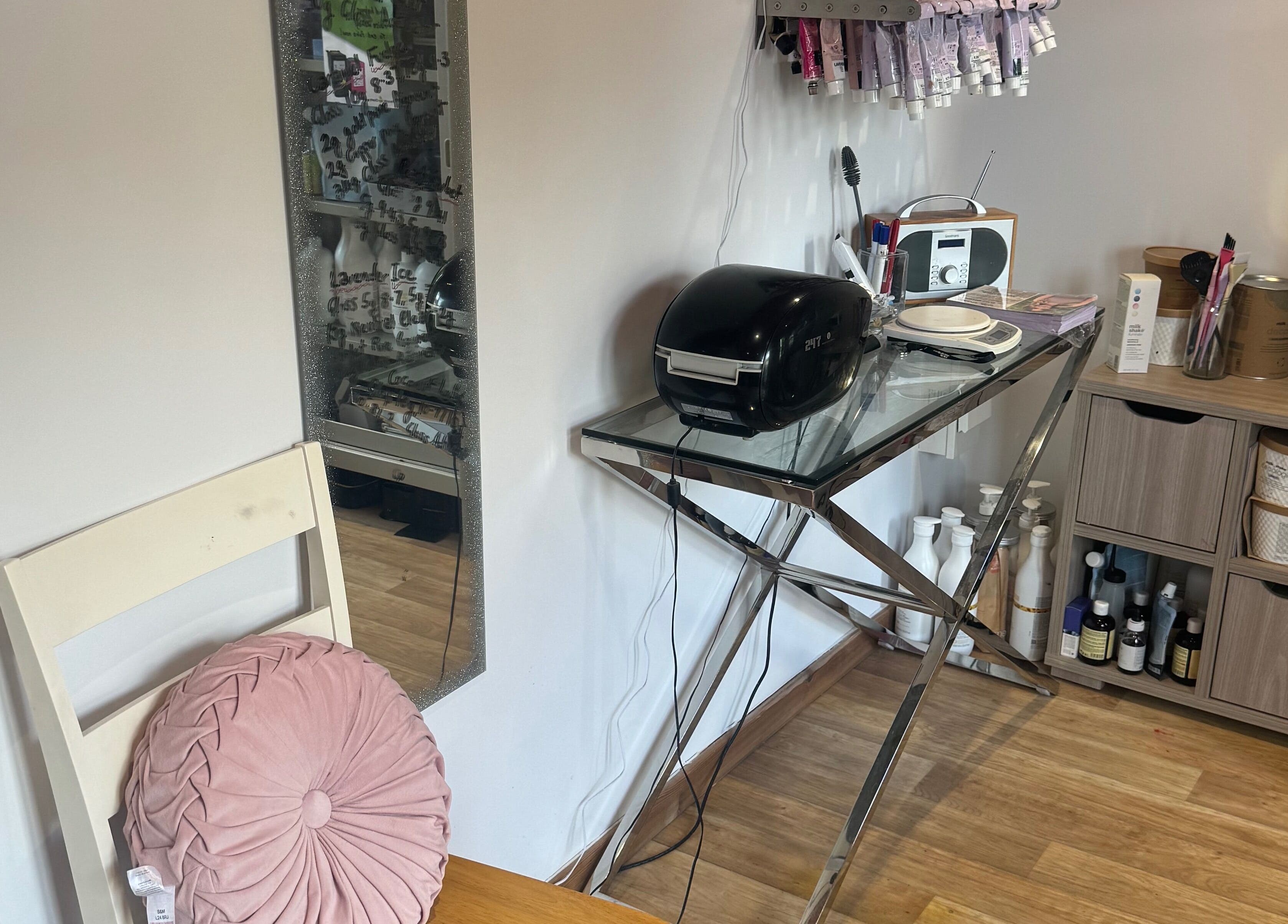 A stylish corner at Charlotte's in Glossop, England, GB with a glass table and beauty supplies.
