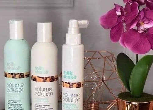 Luxurious haircare products and orchid at Charlotte's, Glossop, England, GB enhance beauty ambiance.