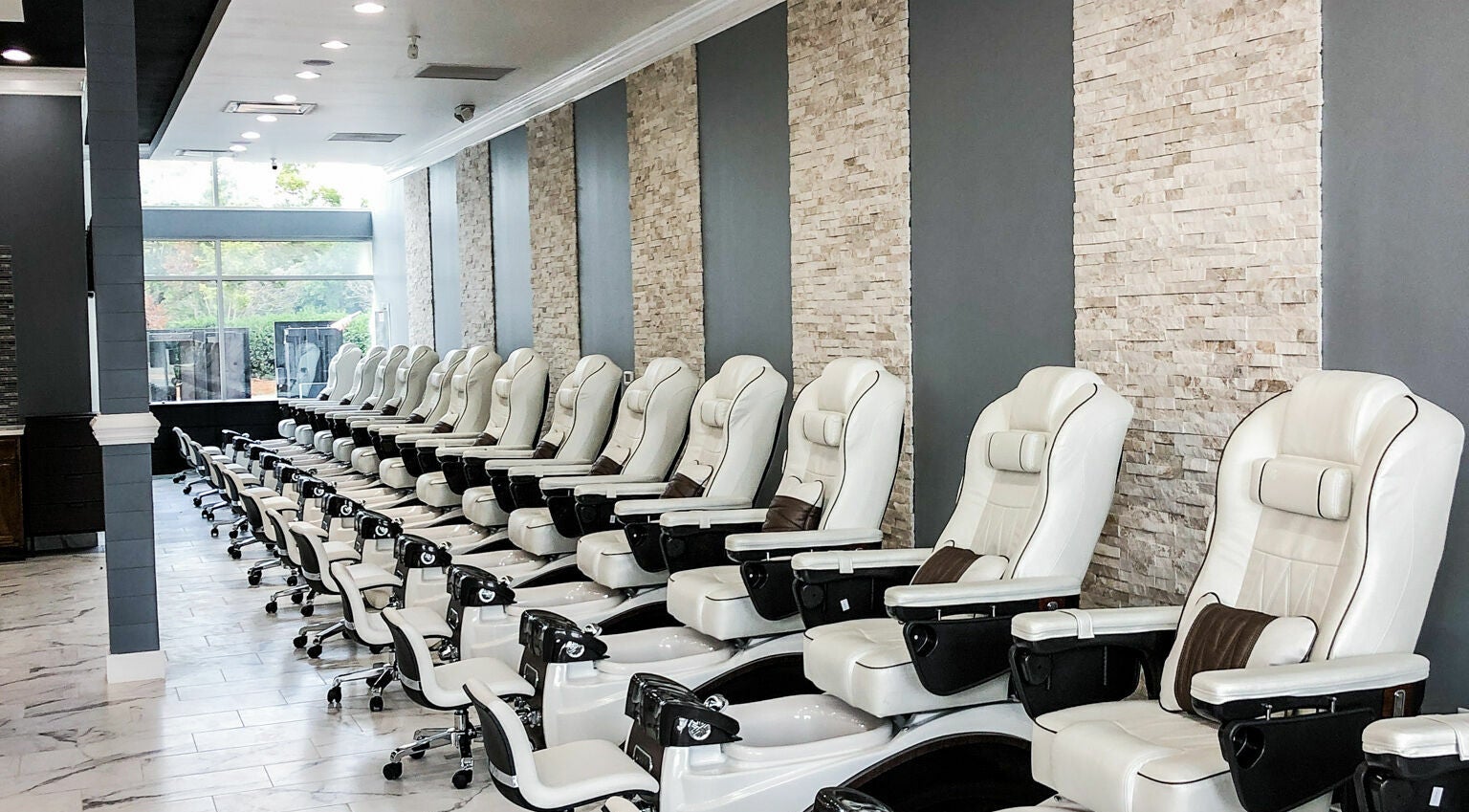 Elegant pedicure chairs at Gloss Nail Bar in Clover, South Carolina, US offering a tranquil experience.