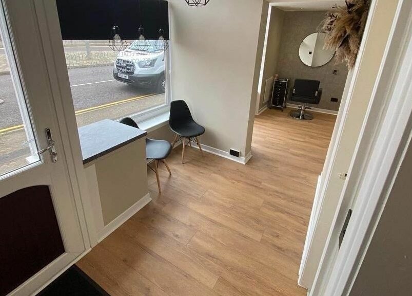 Welcome area of Ashley Allan Hair Replacement Studio, Sauchie, Scotland, with modern decor and stylish seating.