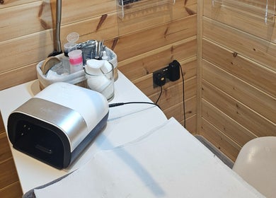 Nail station at The Beauty Room, Peterborough, England, GB, featuring a lamp and tools in a serene setting.