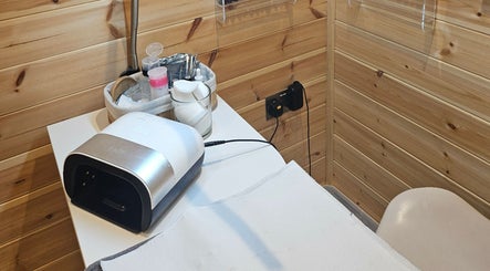 Nail care setup at The Beauty Room in Peterborough, England, GB with tools on a wooden backdrop.