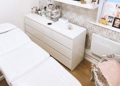 Cozy treatment room at Eden Aesthetic Clinic, Dublin, County Dublin, IE with plush chair and modern bed.