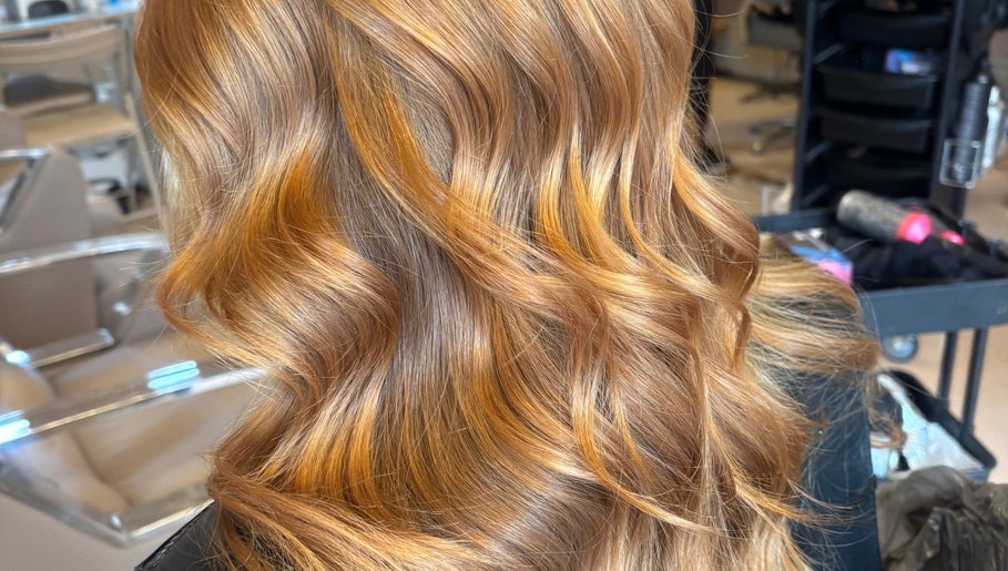Lustrous golden hair waves styled at Claire Sinclair Hair in Tillicoultry, Scotland, GB.