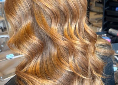 Lustrous golden hair waves styled at Claire Sinclair Hair in Tillicoultry, Scotland, GB.