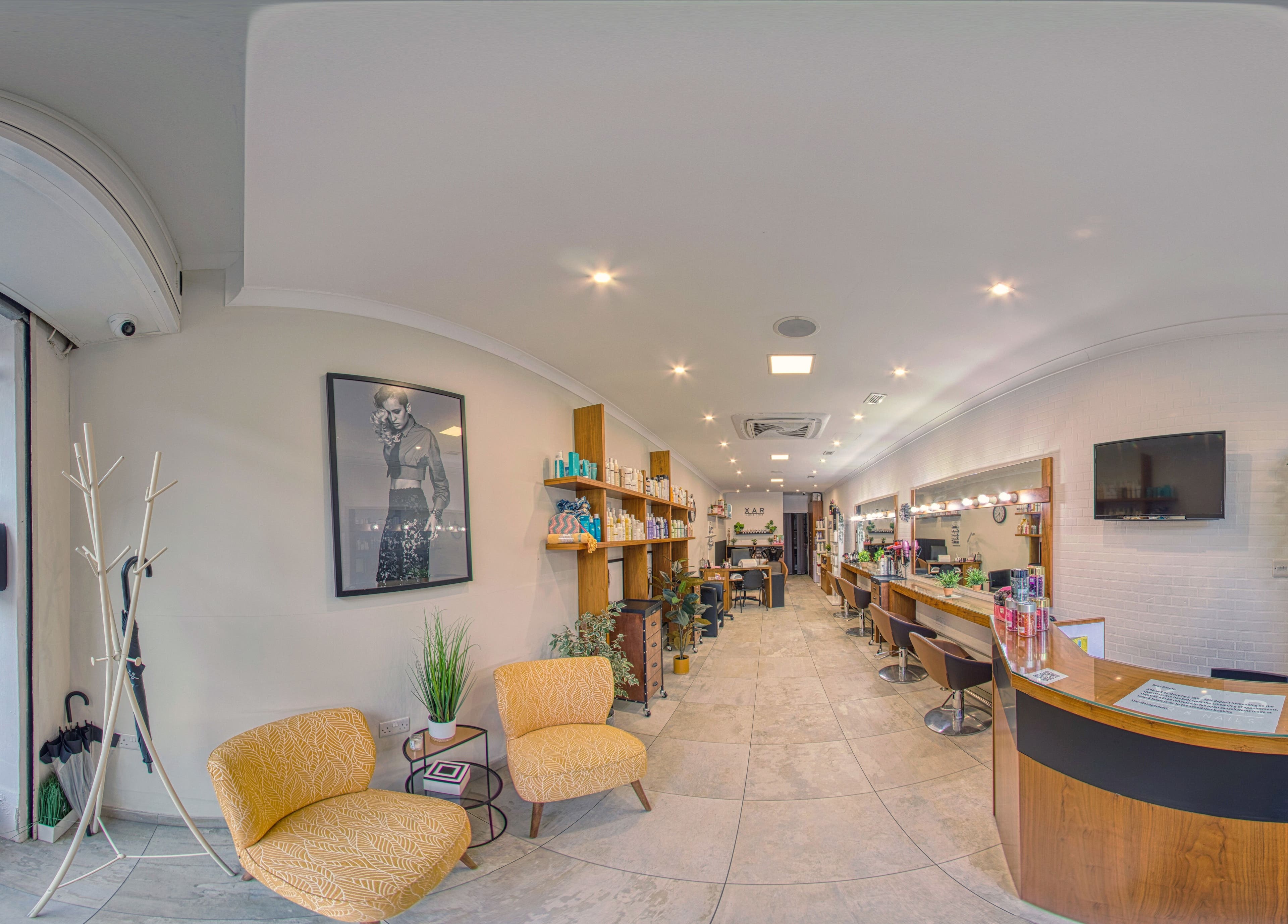 Modern salon interior at Xar Hair & Nails in Is-Swieqi, MT, featuring stylish seating and professional stations.