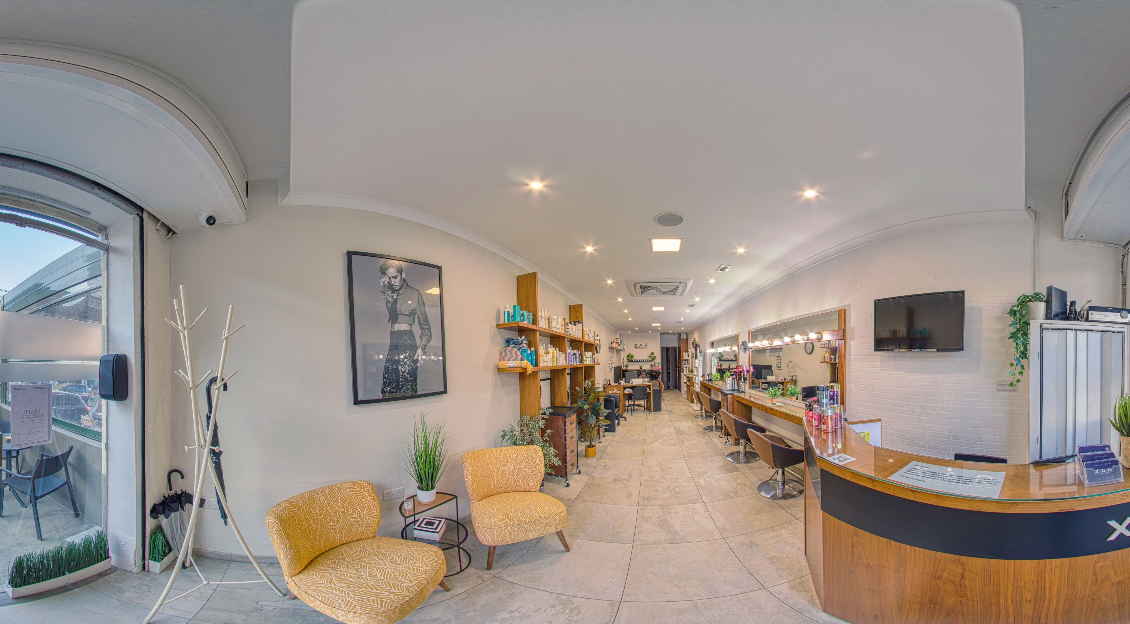 Modern salon interior at Xar Hair & Nails in Is-Swieqi, MT, featuring stylish seating and professional stations.