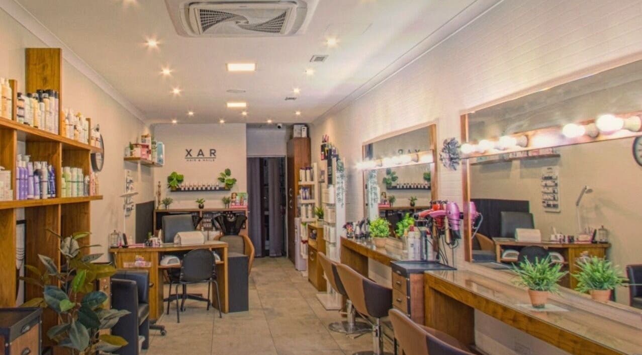 Chic interior of Xar Hair & Nails, Is-Swieqi, MT showcasing stylish salon stations with modern decor.