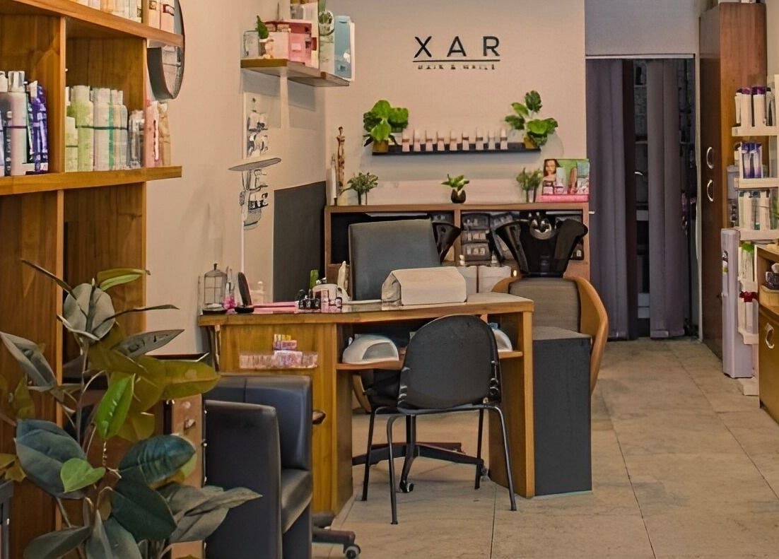 Relaxing interior of Xar Hair & Nails in Is-Swieqi, MT with stylish decor and beauty products on display.